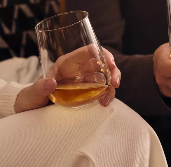 two people holding glasses of Ardray blended scotch whisky