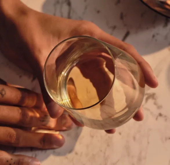 holding glass of blended whisky in hand