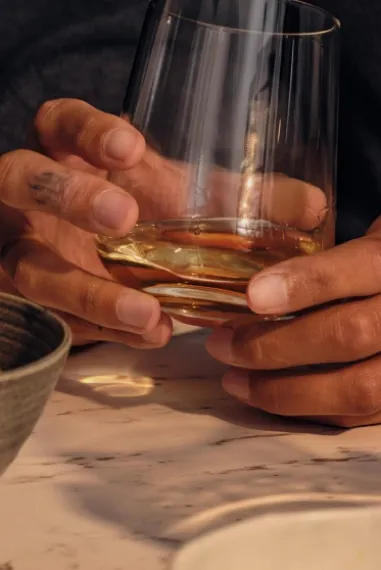 holding glass of Ardray in hand
