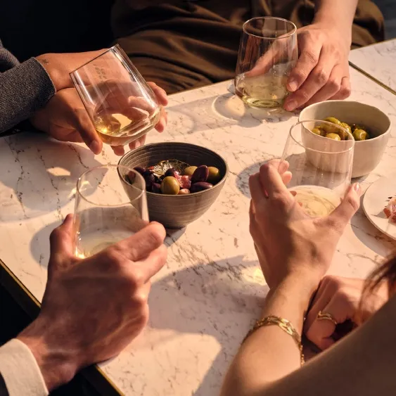 group of people at a table drinking whisky