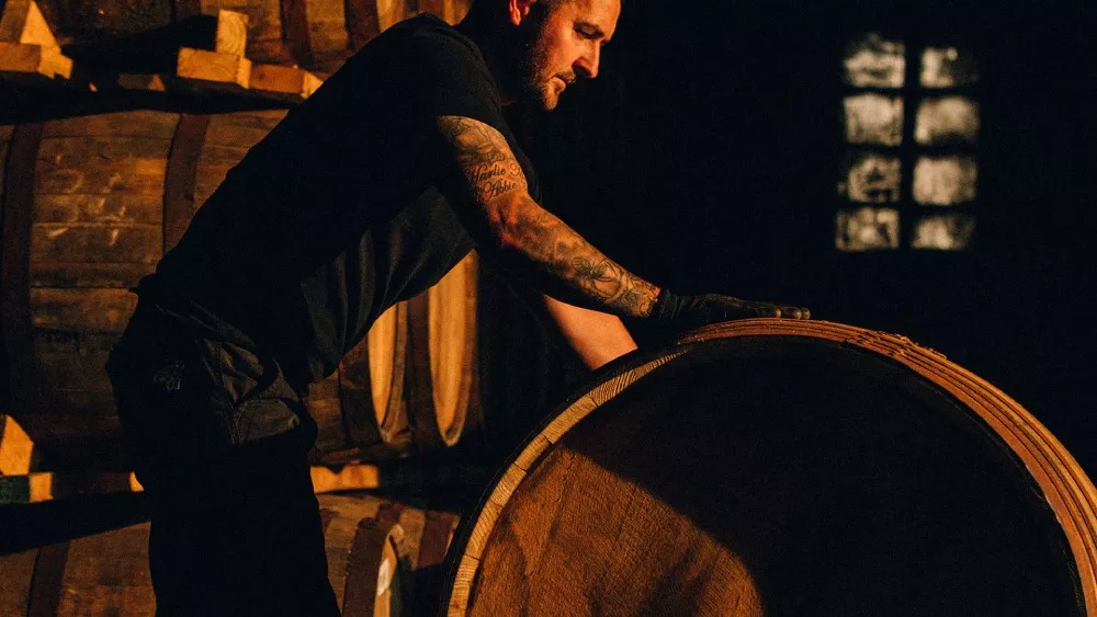 Man rolling barrel in Distillery