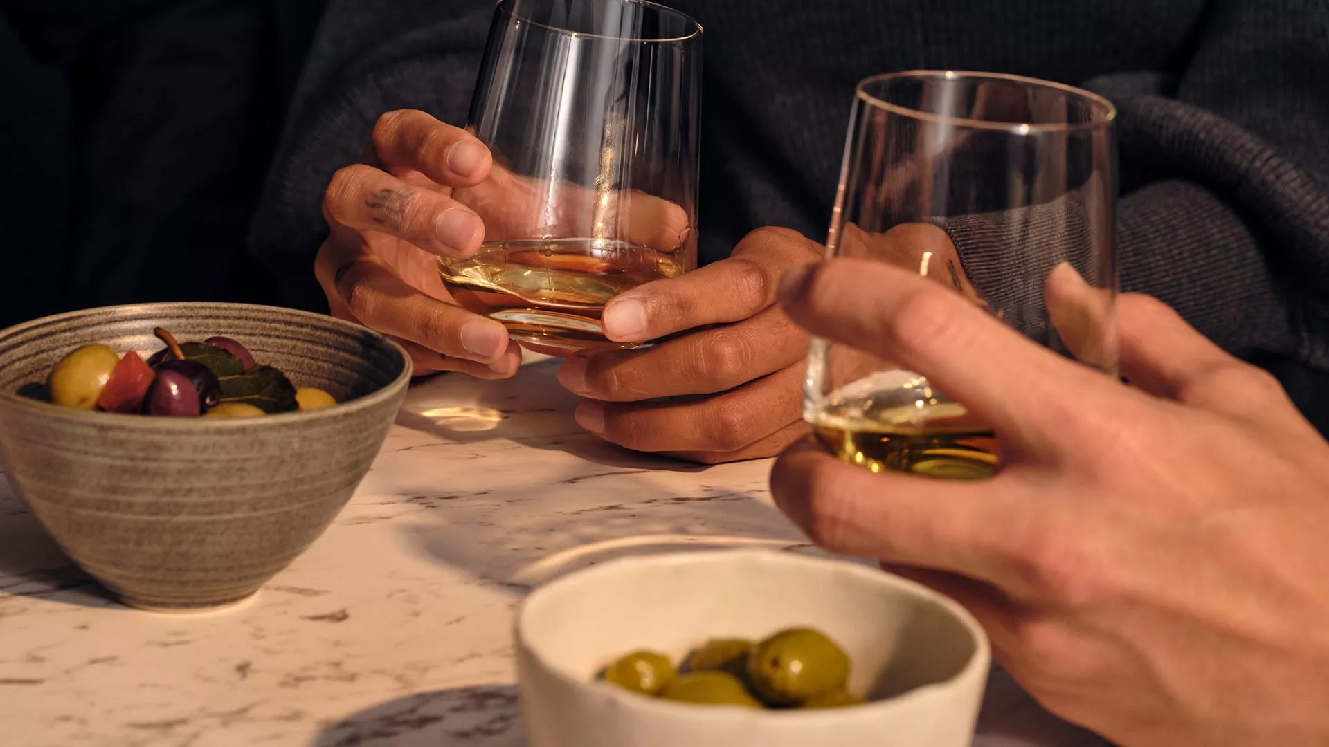 tasting at table with people holding glasses of scotch whisky