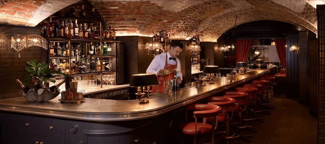 Barman pouring whisky cocktail
